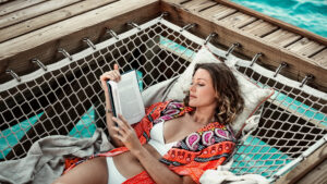 ©South Bank | Woman Relaxing on lounger Reading Book