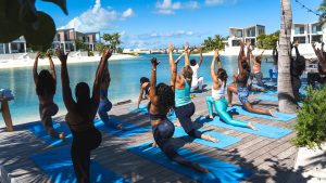 Group of people doing yoga on the side of the lagoon at Southbank